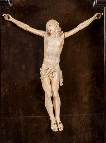 An ivory Christ in a wooden display case